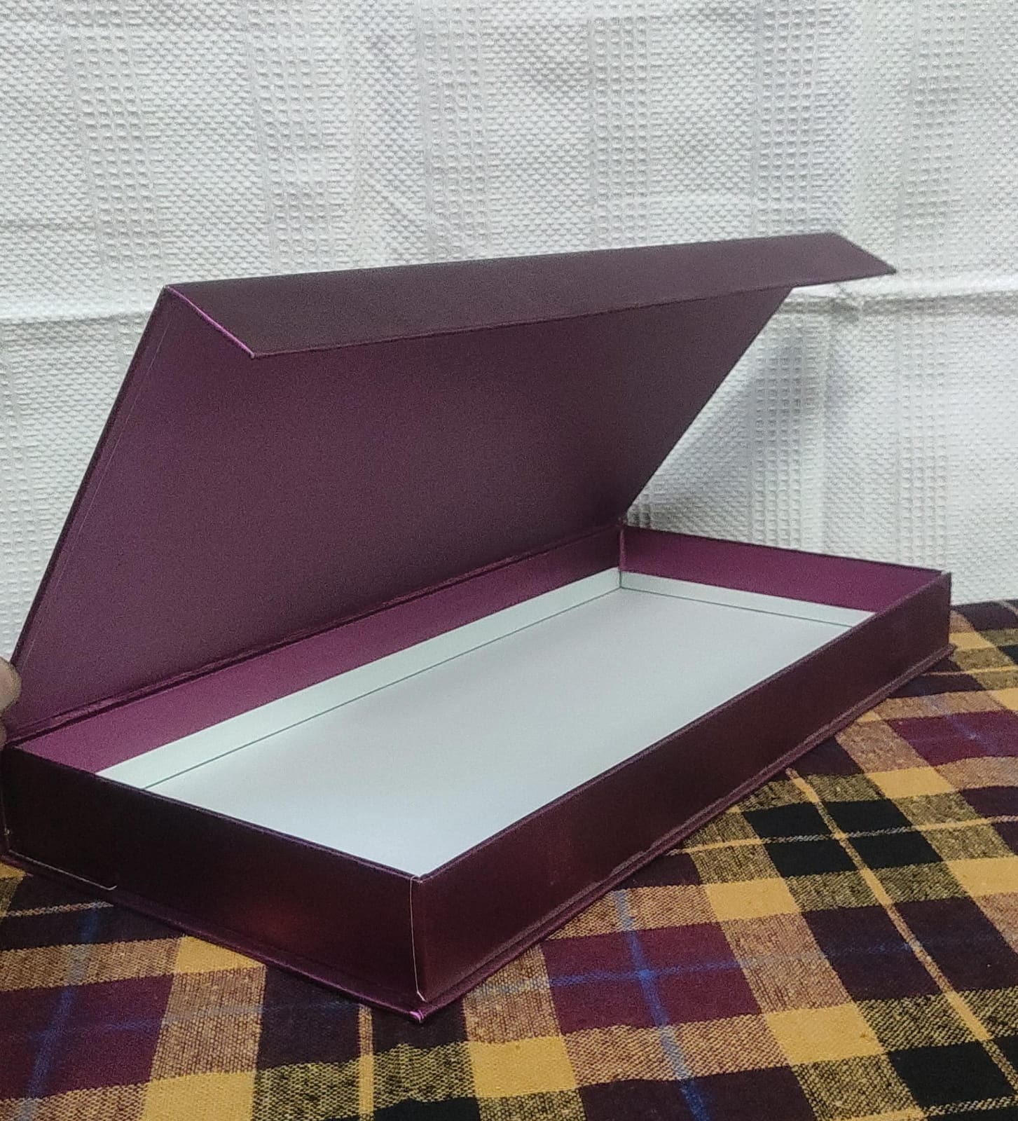 Open maroon rigid gift box with white interior